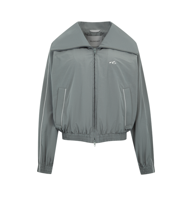Image 1 of 3 - GREY - BALENCIAGA High Collar Tracksuit Jacket featuring techno cotton poplin, a long high stand up collar, double-ended zip fastening, dropped shoulders, reflective piping, 2 zipped slash pockets, gathered cuffs and waistline and reflective effect artwork printed on the chest. 50% cotton, 50% polyamide. Lining: 100% polyester. Made in Italy.