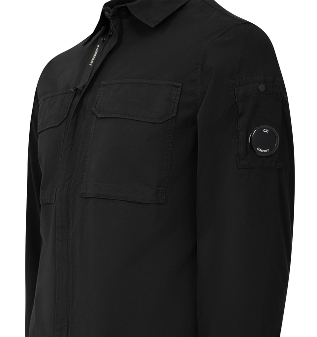 Image 3 of 3 - BLACK - C.P. COMPANY Organic Gabardine Zipped Lens Overshirt featuring classic collar, two-way concealed zip fastening, two chest flap pocket, lens detail, adjustable button cuffs and regular fit. 100% cotton. Made in Italy. 