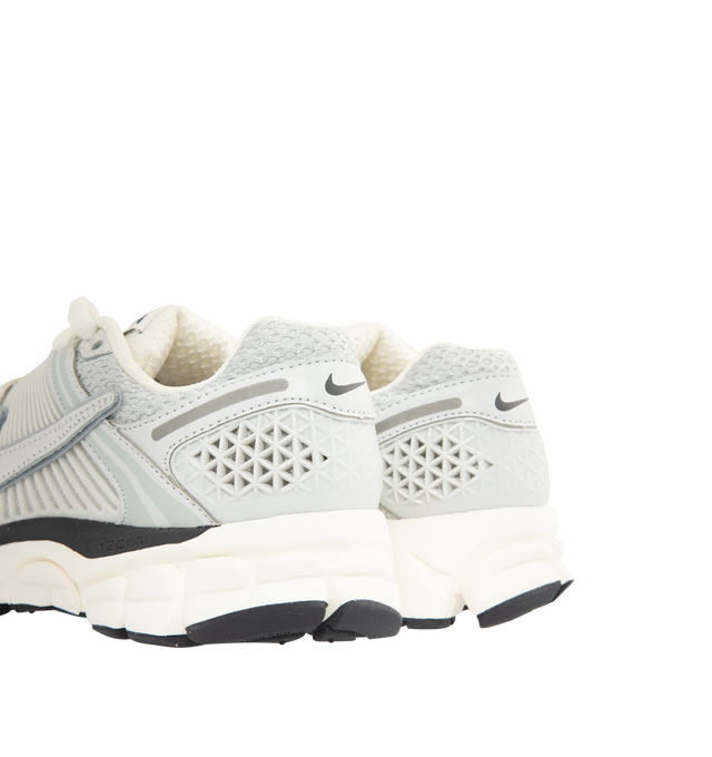 Image 3 of 5 - GREY - NIKE Zoom Vomero 5 Sneaker featuring real and synthetic leather on the upper, mesh panels and ventilation ports on the heel, Zoom Air cushioning, plastic caging on the side, rubber outsole and reflective details.