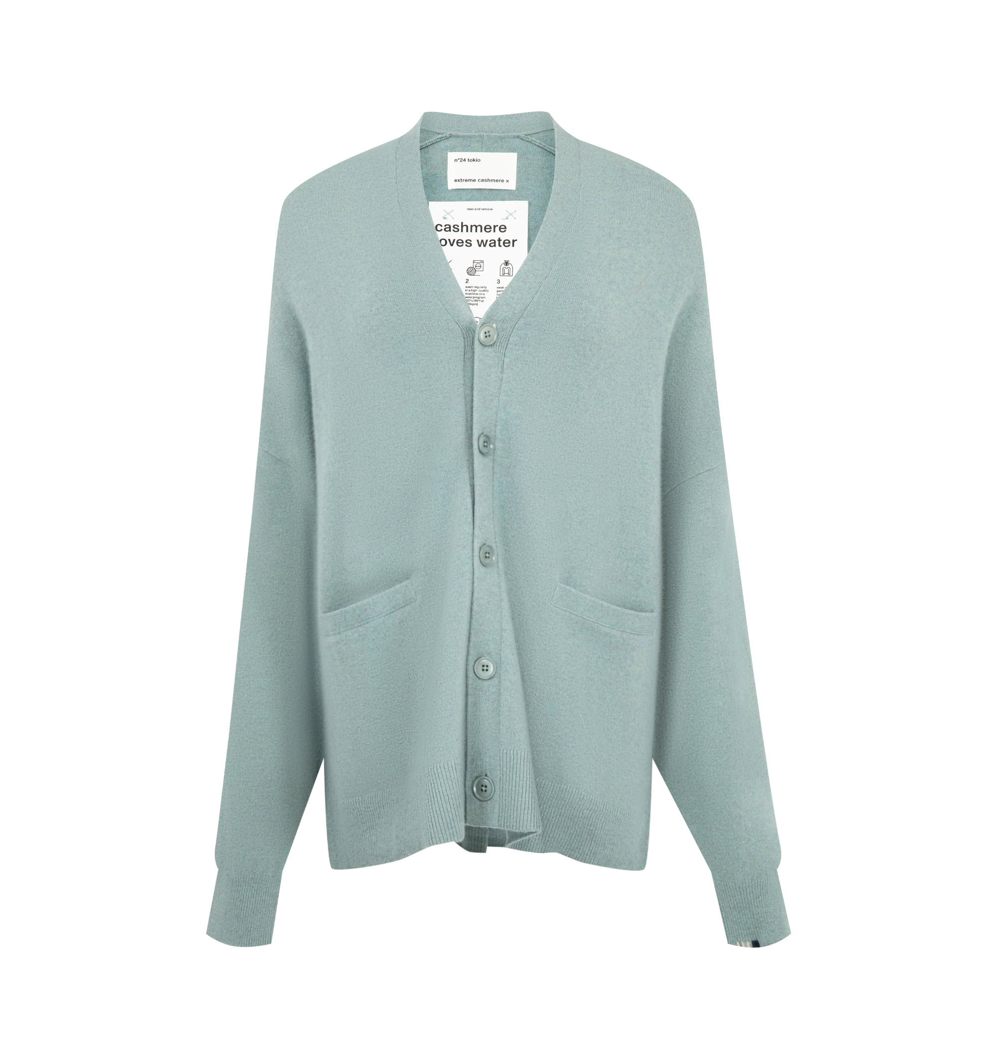 Image 1 of 2 - GREEN - Extreme Cashmere Women's N24 Tokio Cardigan Sweater is crafted from a premium cashmere blend and features a relaxed silhouette with dropped shoulders, two front patch pockets, and a unique side button that allows for adjustable styling. This designer cashmere cardigan combines exceptional softness with versatile functionality, while durable natural corozo buttons add a refined finishing touch. Main Material: 88% Cashmere, 10% Nylon, 2% Elastane.