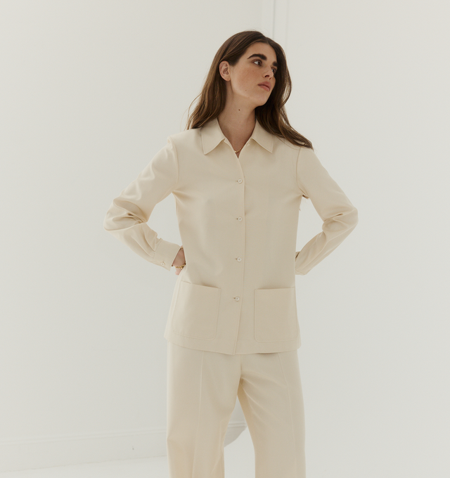 Image 2 of 3 - YELLOW - THE ROW Lucetta Shirt featuring classic button-up shirt in richly textured silk shantung with regular fit, front patch pockets and exposed front placket with horn buttons. 100% silk. Made in Italy.