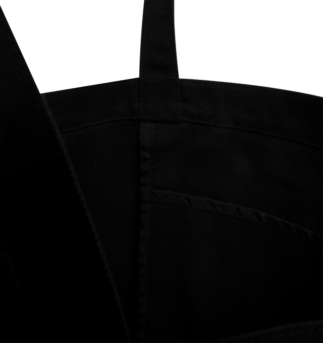 Image 3 of 3 - BLACK - CARHARTT WIP Canvas Graphic Tote featuring dearborn canvas 11.4 oz, allover graphic print, unlined with reinforced seams, swinging inner pocket and square Label. 7 x 46 x 14 cm; 15 L capacity.