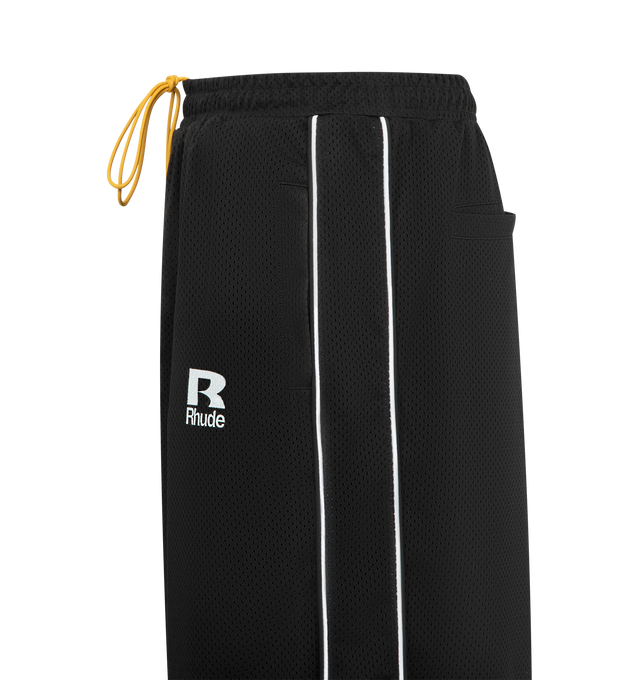 Image 3 of 3 - BLACK - RHUDE Piping Parachute Track Pants featuring concealed drawstring at elasticized waistband, four-pocket styling, mock fly, logo printed at front, tucks at knees, drawstring at elasticized cuffs, piping at outseams and full polyester satin lining. 70% cotton, 30% polyester. Lining: 100% polyester. Made in United States.  
