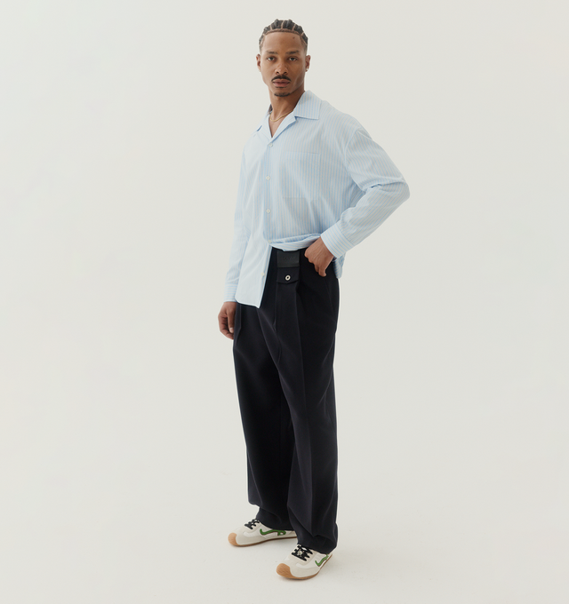 Image 2 of 5 - NAVY - LOEWE Trousers in medium-weight cavalry twill featuring pleats at the front, relaxed fit, regular length, mid waist, straight leg, concealed zip fly, buttoned coin pocket, seam pockets, rear patch pocket and LOEWE embossed leather patch placed at the front. Wool. Made in Italy.