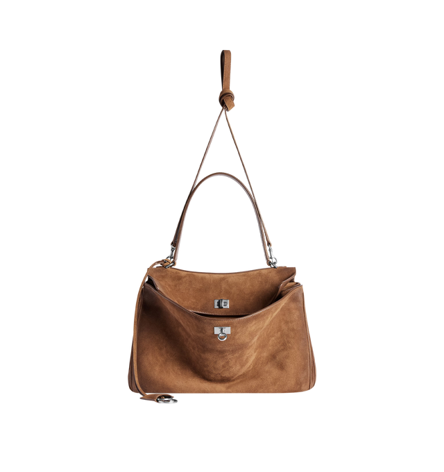 Image 2 of 4 - BROWN - BALENCIAGA Rodeo Handbag Medium in waxed suede calfskin and smooth calfskin featuring one handle, removable shoulder strap, removable cloche cls with two split rings, aged-silver hardware, turn lock closure, wide front pocket, 1 main compartment, 1 inner zipped pocket, 2 flat pockets at back, side snaps, 4 brass feet and nappa lambskin lining. L13.8 x H9.2 x W4.3 inch. Calfskin. Made in Italy.