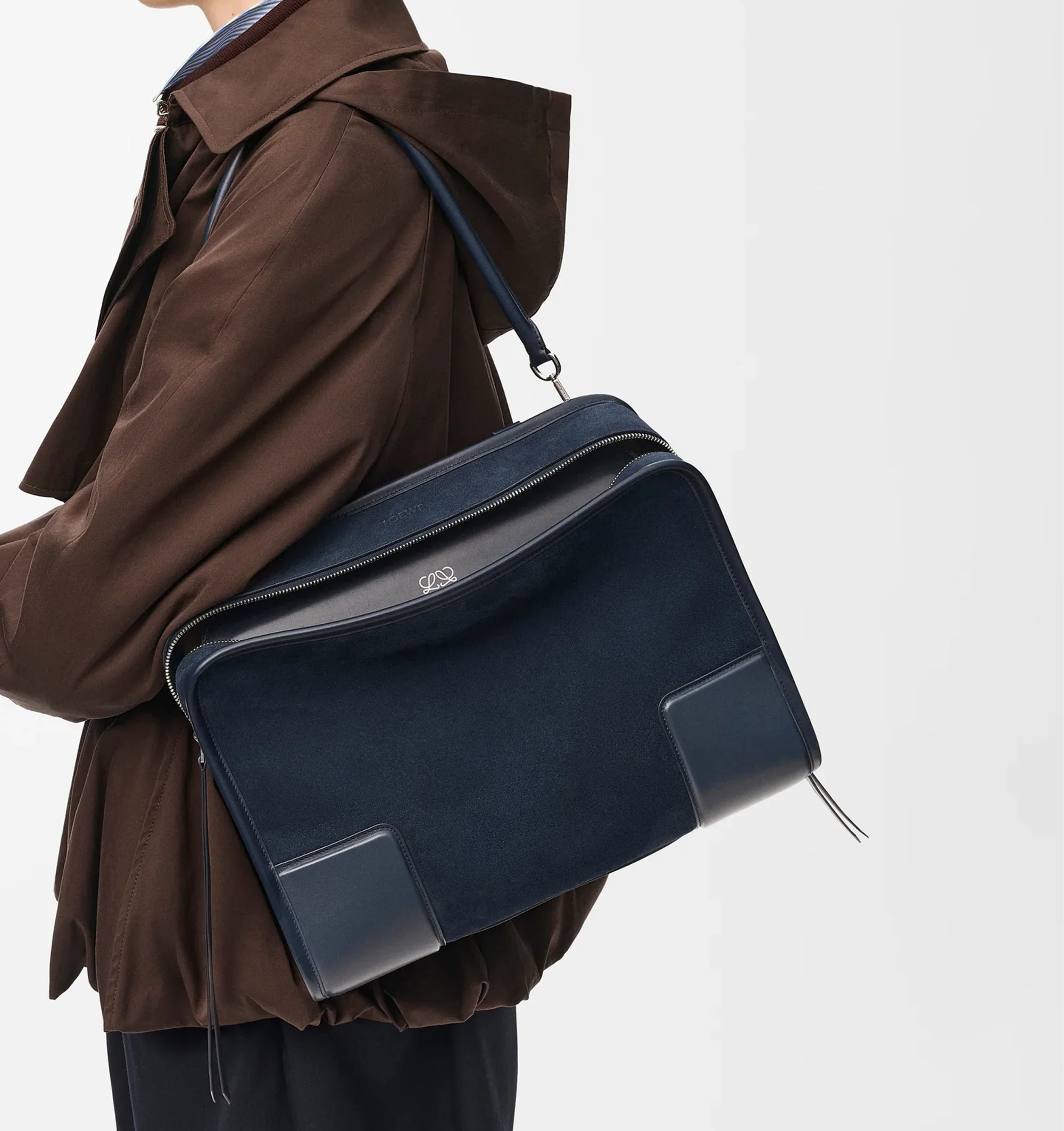 Image 2 of 16 - NAVY - Loewe Large Amazona 180 Bag in suede featuring a relaxed silhouette anchored by a single toron top handle, designed to be carried open while a concealed closure secures the main compartment, removable shoulder and crossbody straps, zip closure with two leather zip pullers, two compartments, main compartment closed with magnetic closure, internal flat pocket, left side d-ring for customization, suede and nappa lambskin lining, embossed LOEWE and embossed double L branding. Suede/calf.