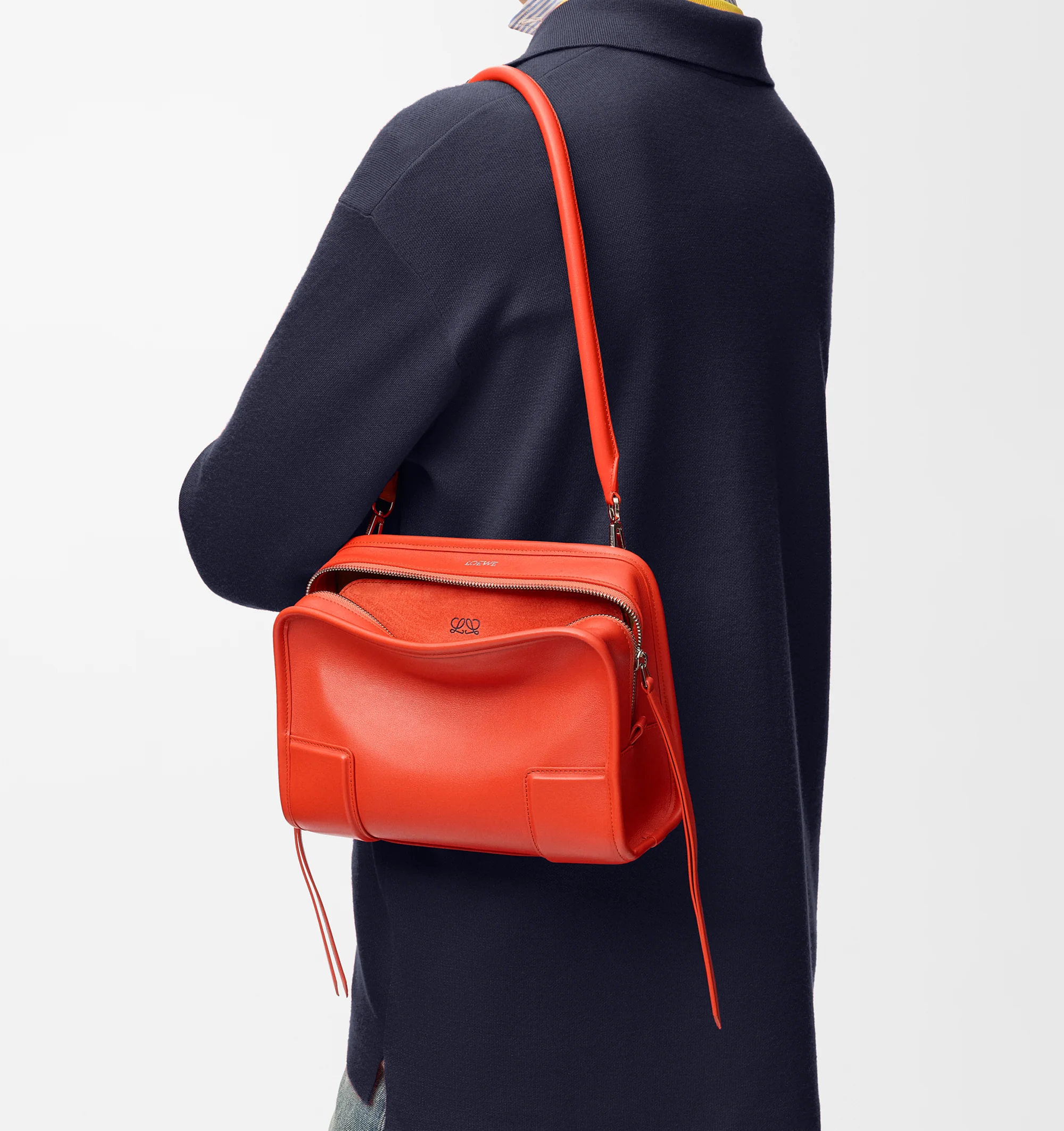 Image 2 of 17 - ORANGE - Loewe Small Amazona 180 Bag in leather features a relaxed silhouette anchored by a single toron top handle, designed to be carried open, while a concealed closure secures the main compartment, three carry options: short handle, removable shoulder strap and crossbody, zip closure with two leather zip pullers, two compartments, main compartment closed with magnetic closure, internal flat pocket, left side d-ring for customization, nappa lambskin lining, and embossed double L branding.