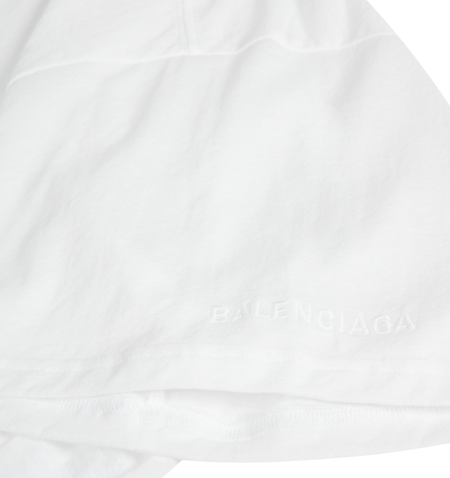 Image 3 of 3 - WHITE - BALENCIAGA Transparent Top featuring transparent jersey, crewneck, front seam detail, short sleeves, asymmetric hem construction with elongated back, rounded, fluid volume at the back and embroidered Balenciaga logo on the left sleeve. 70% cotton, 30% polyamide. Made in Portugal. 