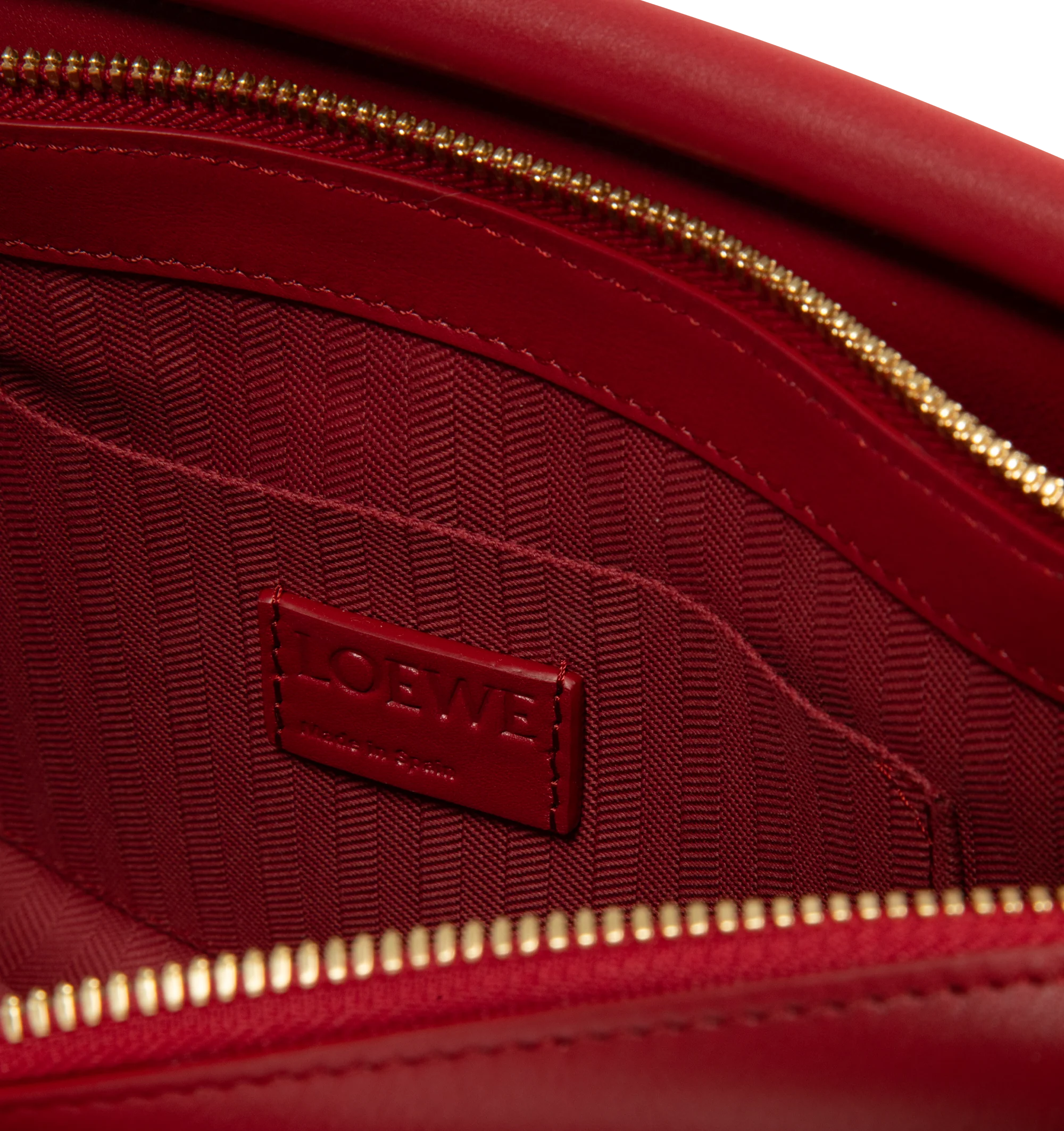 Image 3 of 3 - RED - Loewe Small Whisker Bag is crafted from black glazed calfskin and features a slouchy silhouette with a structured handle and oversized zip opening. Designed for shoulder, crossbody, or hand carry, it includes a detachable strap with rotating dog clips, articulated zipper pulls, foldable D-rings, an exterior flat pocket, and an interior flat pocket. Gold-tone hardware and embossed Loewe and Double L branding complete the design. Fits a large phone, small wallet, sunglasses, and keys. Mai
