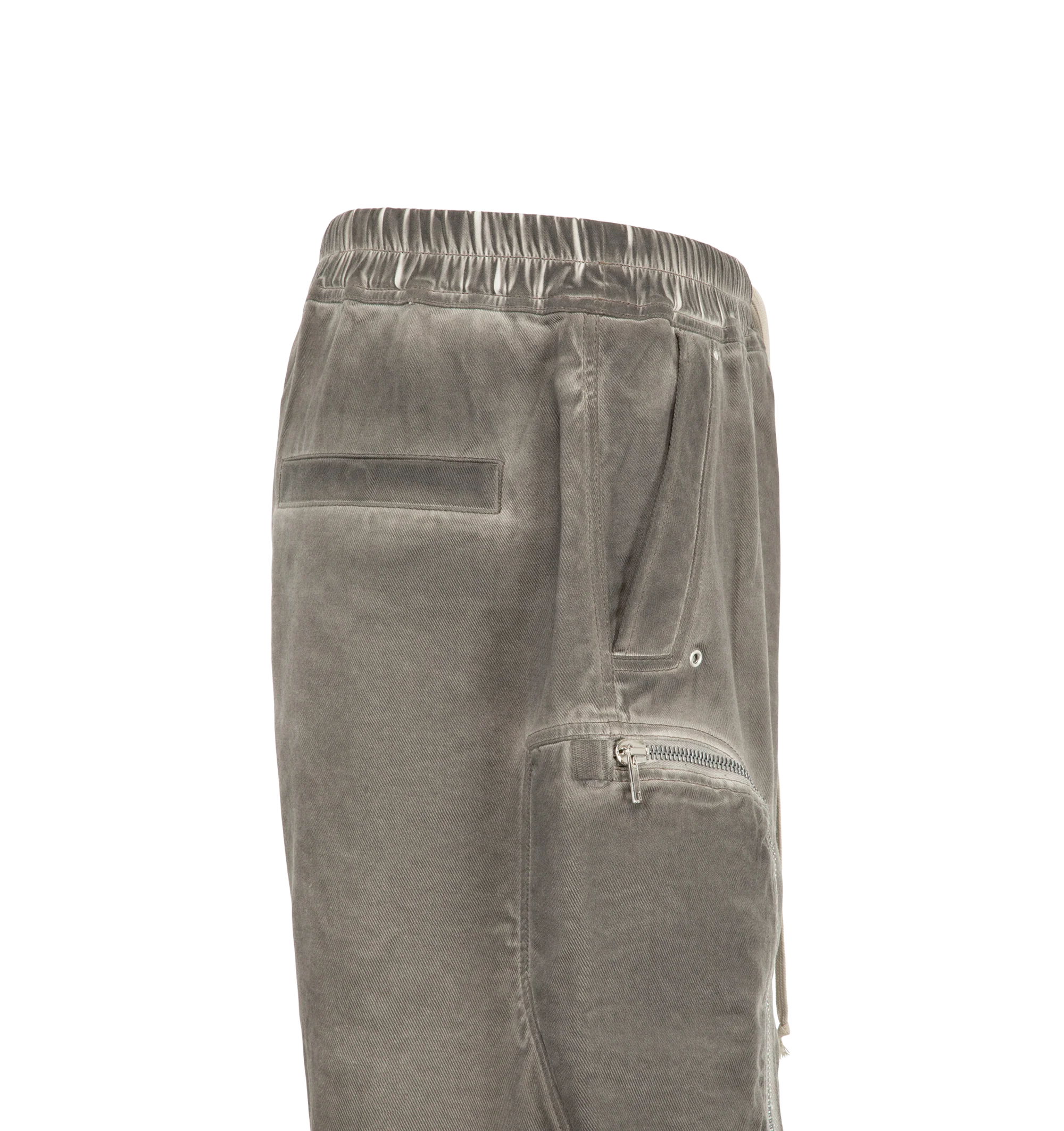 Image 3 of 3 - GREY - Rick Owens Drkshdw Men's Bauhaus Shorts are crafted from 100% cotton 13oz Lido Wash denim and feature a knee-length silhouette with a low dropped crotch. Designed with an elasticized waistband and drawstring closure, these designer shorts include side pockets, signature round Bauhaus zip pockets at the front thigh, and a webbing tab with eyelet detailing. Back jet pockets complete the utilitarian design. The medium-weight denim is overdyed and stone washed to achieve an irregular, live
