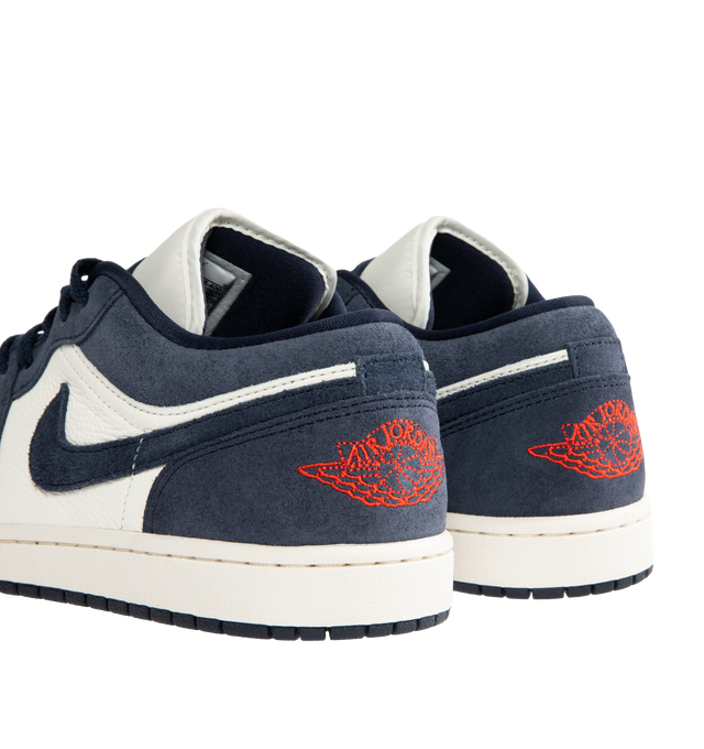 Image 3 of 5 - NAVY - JORDAN Air Jordan 1 Low SE Sneaker featuring leather in the upper, encapsulated Nike Air-Sole unit, rubber in the outsole, Wings logo on heel and Jumpman on the tongue. 