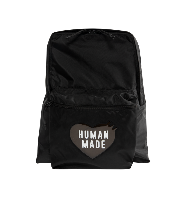 Image 1 of 3 - BLACK - HUMAN MADE Daypack featuring lightweight nylon Oxford exterior, PVC heart logo on the front, two-way zip closure, logo printed on top handle, front zip pocket, shoulder strap features a leather brand logo panel and one interior laptop sleeve. Capacity: around 20 L. 39cm x 34cm x 17cm.