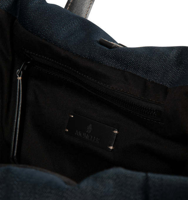Image 3 of 3 - BLUE - Moncler Mens New Caradoc Tote Bag is crafted from denim with signature boudin quilting inspired by Moncler puffer jackets. Features leather trim and handles, adjustable and detachable shoulder strap, clasp closure, interior zip pocket, metal logo, and down-filled construction. Exterior: 75% Cotton, 24% Polyester, 1% Elastane/Spandex; Lining: 100% Cotton; Padding: 90% Down, 10% Feather; Leather Inserts: Calf Leather. Dimensions: 45cm L x 35cm H x 20cm D. Made in Romania. 