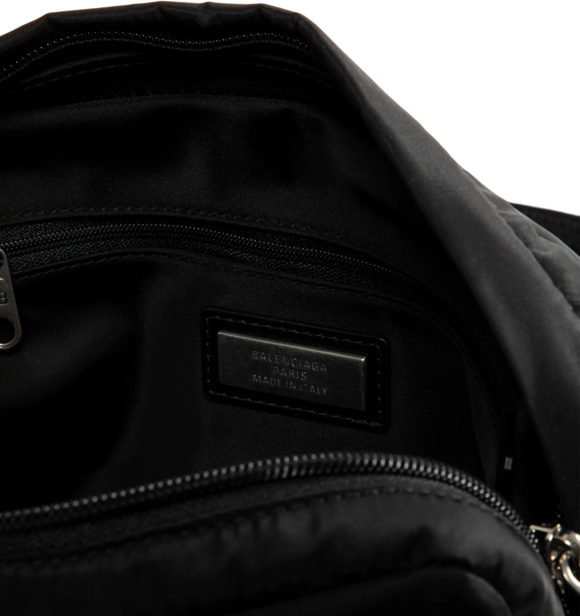 Image 3 of 3 - BLACK - Balenciaga Men's Sleek Nylon Zip Bag is crafted from lightweight nylon and features a streamlined silhouette designed for versatile everyday wear. Finished with an adjustable shoulder strap for a customizable fit, this designer bag features a secure zip closure and a Balenciaga logo debossed with silver at the front for a subtle signature finish. Main Material: Nylon. Closure: Zipper. Strap: Adjustable Shoulder Strap. Details: Silver Debossed Balenciaga Logo at Front.