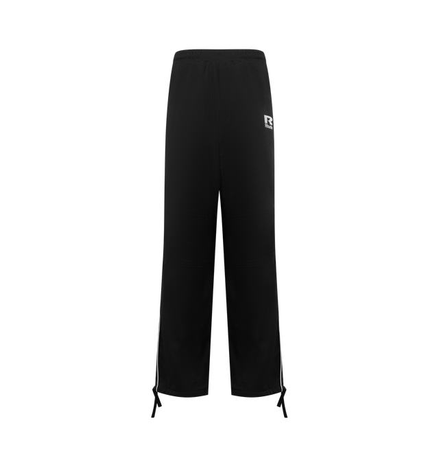 Image 1 of 3 - BLACK - RHUDE Piping Parachute Track Pants featuring concealed drawstring at elasticized waistband, four-pocket styling, mock fly, logo printed at front, tucks at knees, drawstring at elasticized cuffs, piping at outseams and full polyester satin lining. 70% cotton, 30% polyester. Lining: 100% polyester. Made in United States.