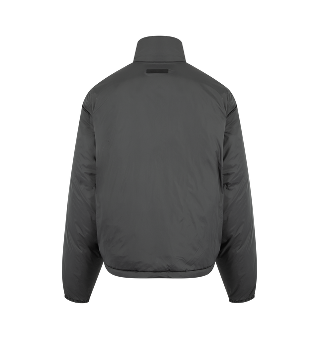 Image 2 of 3 - GREY - FEAR OF GOD ESSENTIALS Ripstop Nylon Puffer Jacket featuring ripstop nylon, matte appearance with water repellant properties, 3D Essentials graphic on the chest, relaxed, rounded silhouette, high neck, side pockets, full zip front, elasticized piping on the cuffs and waist hem, bungee toggles at the waist hem for adjustable styling and a Fear of God Essentials rubberized label stitched at the back collar. 100% matte nylon.