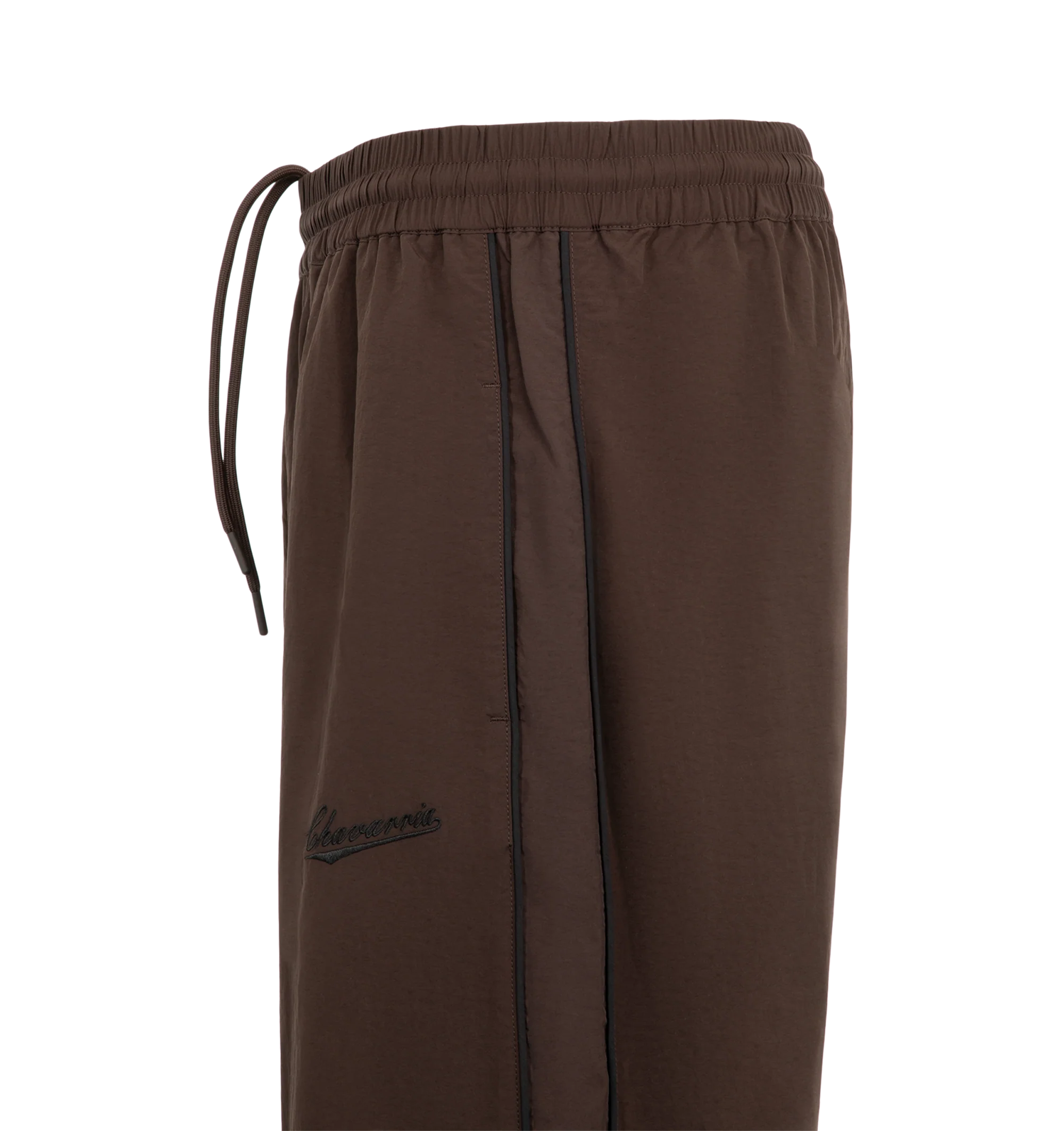 Image 3 of 3 - BROWN - Willy Chavarria Bad Boy Track Pant is crafted from lightweight nylon and features a relaxed athletic silhouette with an elasticated waistband and cuffs. Designed with a concealed drawstring waist, two seam pockets, embroidered logo detailing, and contrast piping along the outseams, the pant delivers the brand's bold sportswear-inspired aesthetic. Main Material: 100% Nylon.