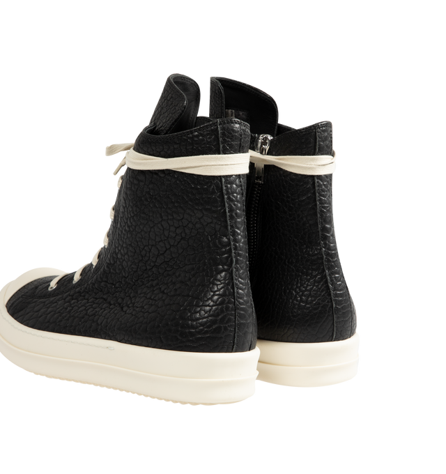Image 3 of 5 - BLACK - Rick Owens Mens High-Top Sneakers feature a pebbled lamb leather and full-grain calf leather upper. Designed with a high-top silhouette, cream rope laces, off-white rubber toe cap, chunky ridged rubber cupsole, and lace-up closure. Upper: Lamb Leather and Calf Leather; Outsole: Rubber. Made in Italy.