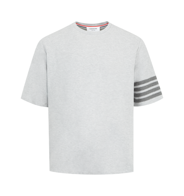 Image 1 of 3 - GREY - THOM BROWNE Textured Pique 4 Bar Tee featuring ribbed neckline, buttoned side vents with RWB grosgrain trim, stepped hem, engineered 4-bar detailing, name tag appliqu and signature striped grosgrain loop tab. 100% cotton. Made in Italy.