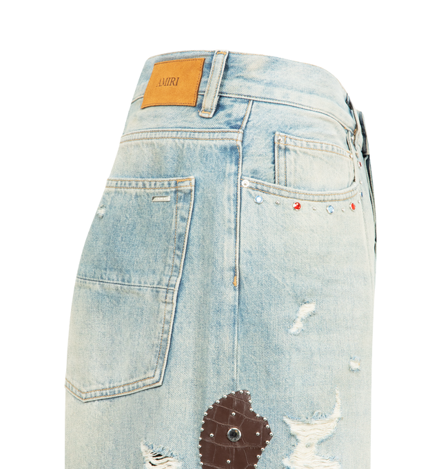 Image 4 of 4 - BLUE - AMIRI Bones Studded Baggy Jean featuring croc embossed leather bone appliques and stud detailing, distressed throughout, stud embellishments, rhinestone rivets and baggy fit. 100% cotton. Made in Italy.