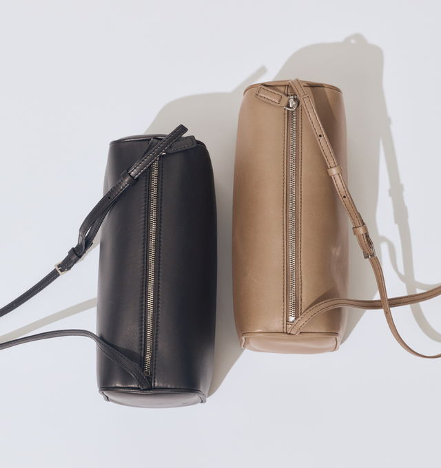 Image 2 of 4 - BROWN - THE ROW 90's Crossbody Bag in Leather featuring crossbody bag in smooth nappa leather with softly rounded edges, leather piping, and adjustable slim leather strap. 8.7 x 4.5 x 3.5 in. 100% lambskin leather. Made in Italy.