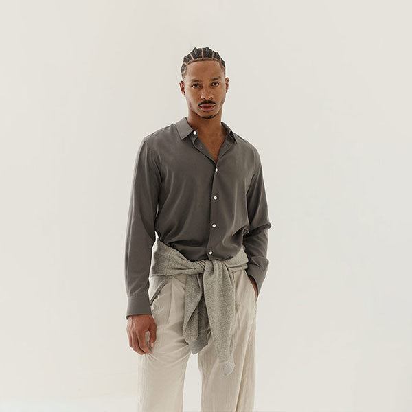 Man wearing a gray shirt and beige pants by The Row