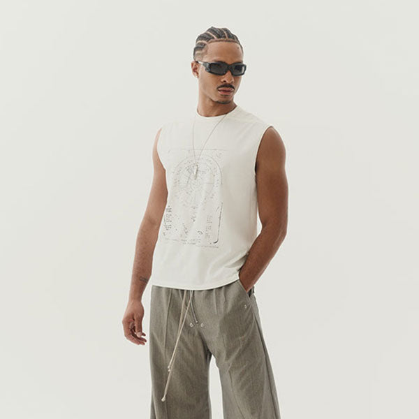 Man wearing a sleeveless beige top and gray pants by Rick Owens