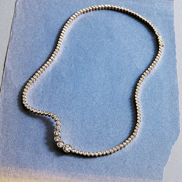 Sophie Bille Brahe diamond necklace on a blue background