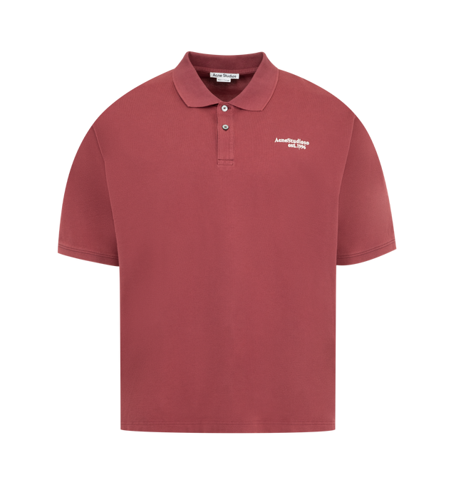 Image 1 of 2 - RED - ACNE Washed Logo Polo featuring short sleeves, relaxed fit, hip length, polo collar, two-button closure, sun-kissed finish and Acne Studios logo on the chest. 100% cotton.
