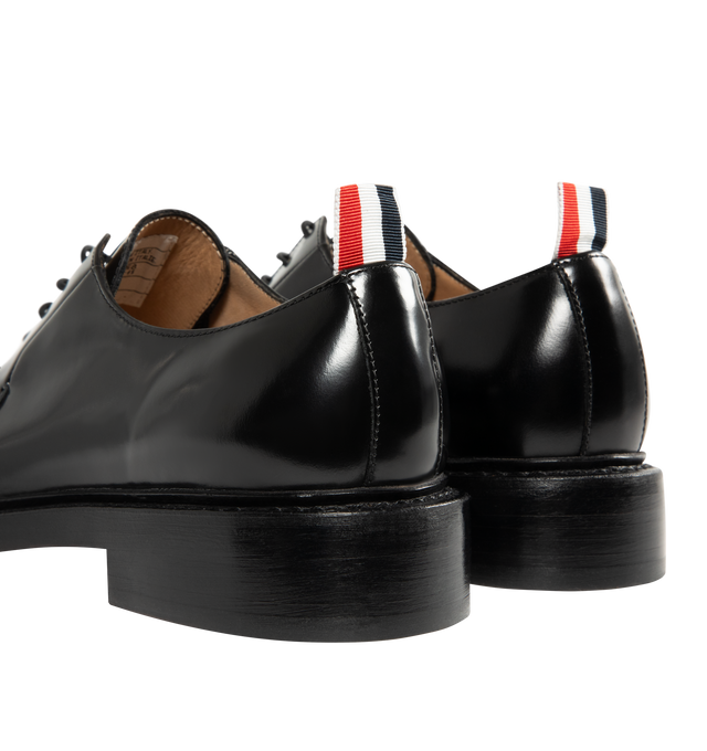Image 3 of 4 - BLACK - THOM BROWNE Soft Spazzolatio Blucher Shoe featuring soft spazzolato leather with a high-shine finish, nipped toe, lace-up closure, Goodyear-welted leather sole with rubber heel insert, metal taps on heels and signature striped grosgrain loop tab. 100% calf leather. Made in Italy.
