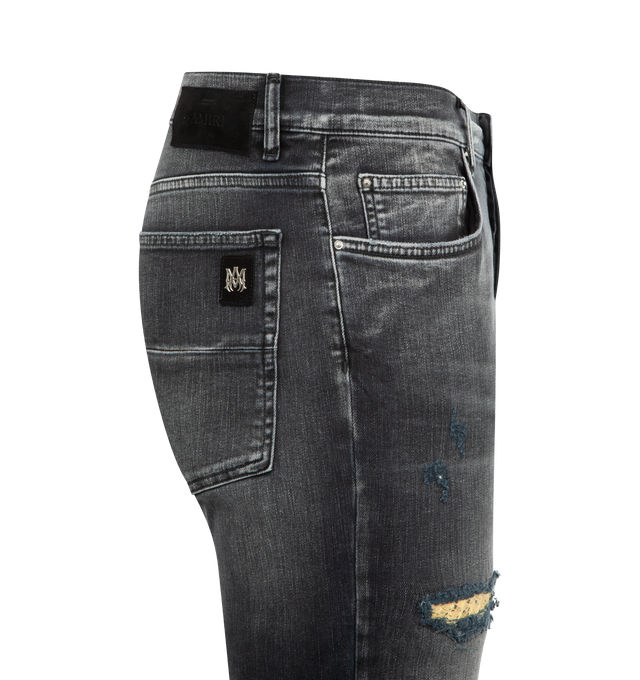 Image 3 of 3 - BLACK - AMIRI Snake Thrasher Skinny Jean featuring button fly closure, 5-pocket styling, intentionally distressed details with snake embossed panels and midweight stretch denim. 92% cotton, 6% elastomultiester, 2% elastane. Made in Italy.