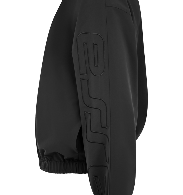 Image 3 of 3 - BLACK - FEAR OF GOD ESSENTIALS Active Trace Half Zip Track Jacket featuring perforated lining for breathability, detailed with an embroidered Essentials active trace logo on the sleeves, relaxed, rounded silhouette, high neck, half-zip front, elasticized cuffs and waist hem and Essentials signature label is at the back collar. 100% polyester.