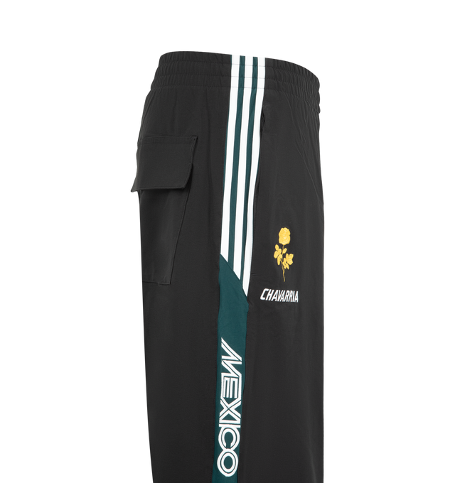 Image 3 of 4 - BLACK - Adidas Mens Convertible Woven Pants feature a woven construction with zip-off lower legs for convertible wear. Designed with an elastic waistband, zip closures at the knees, applied 3-Stripes along the upper and lower legs, embroidered logos and artwork, and side pockets. Made in Indonesia.