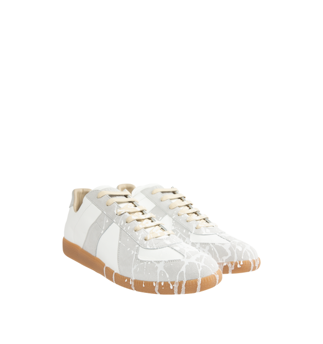 Image 2 of 5 - WHITE - MAISON MARGIELA High Quality Luxury Sneakers featuring a classic low-top silhouette, contrast of matte leather and a patent sprayed finish, paint splatter detail, lace-up construction and rubber sole. Made in Italy. 