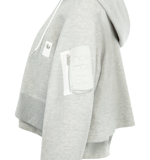 Image 3 of 3 - GREY - SACAI Sponge Sweat x Nylon Twill Hoodie featuring padded cotton-blend jersey hoodie, drawstring at hood, two-way zip closure, logo-engraved press-stud tab at chest, concealed welt pockets, rib-knit hem and cuffs, cropped hem, utility pocket and pen slots at sleeve, dropped shoulders and nylon satin underlay. 62% cotton, 38% polyester. Lining: 55% polyester, 44% cotton, 1% polyurethane. Fill: 100% polyester. Made in Japan. 