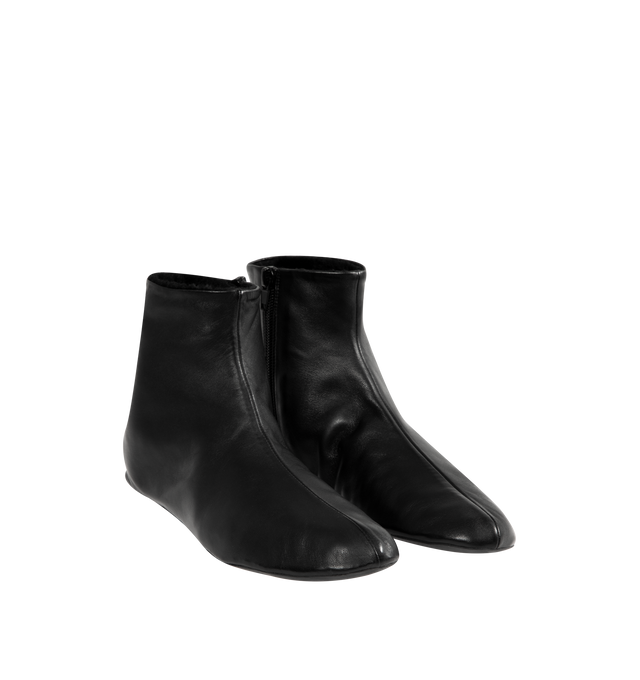 Image 2 of 4 - BLACK - THE ROW Stella Boot featuring minimal ankle boot in smooth nappa leather with inner side zip closure, soft shearling lining and flexible rubber-coated sole. 100% lambskin leather. Synthetic sole. Made in Italy.