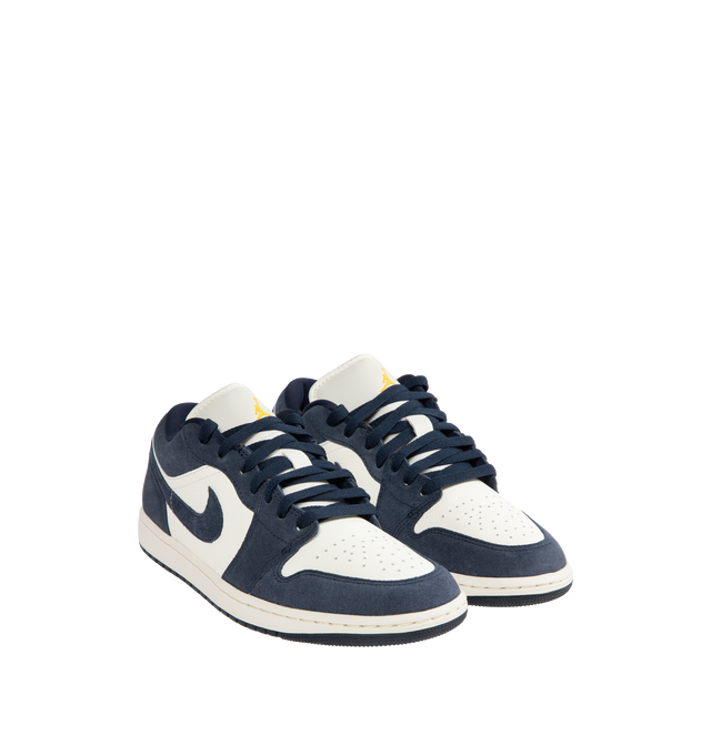 Image 2 of 5 - NAVY - JORDAN Air Jordan 1 Low SE Sneaker featuring leather in the upper, encapsulated Nike Air-Sole unit, rubber in the outsole, Wings logo on heel and Jumpman on the tongue.