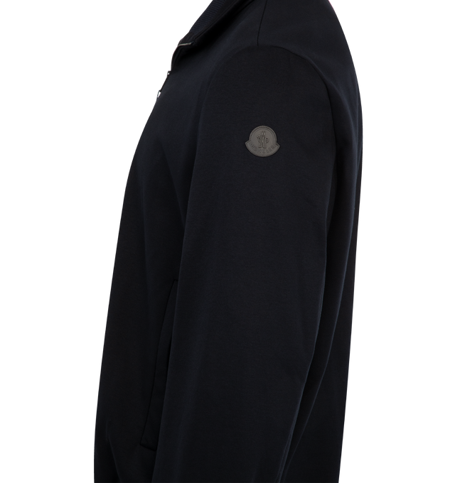 Image 3 of 3 - NAVY - MONCLER Simorre Jacket featuring cotton jersey technique, Airsoft lining, stand collar, zipper closure, zipped pockets, inner patch pocket with snap button closure, elastic cuffs, inner fabric description label and logo patch. 90% cotton, 10% polyamide/nylon. Lining: 100% polyester. Made in Romania. 
