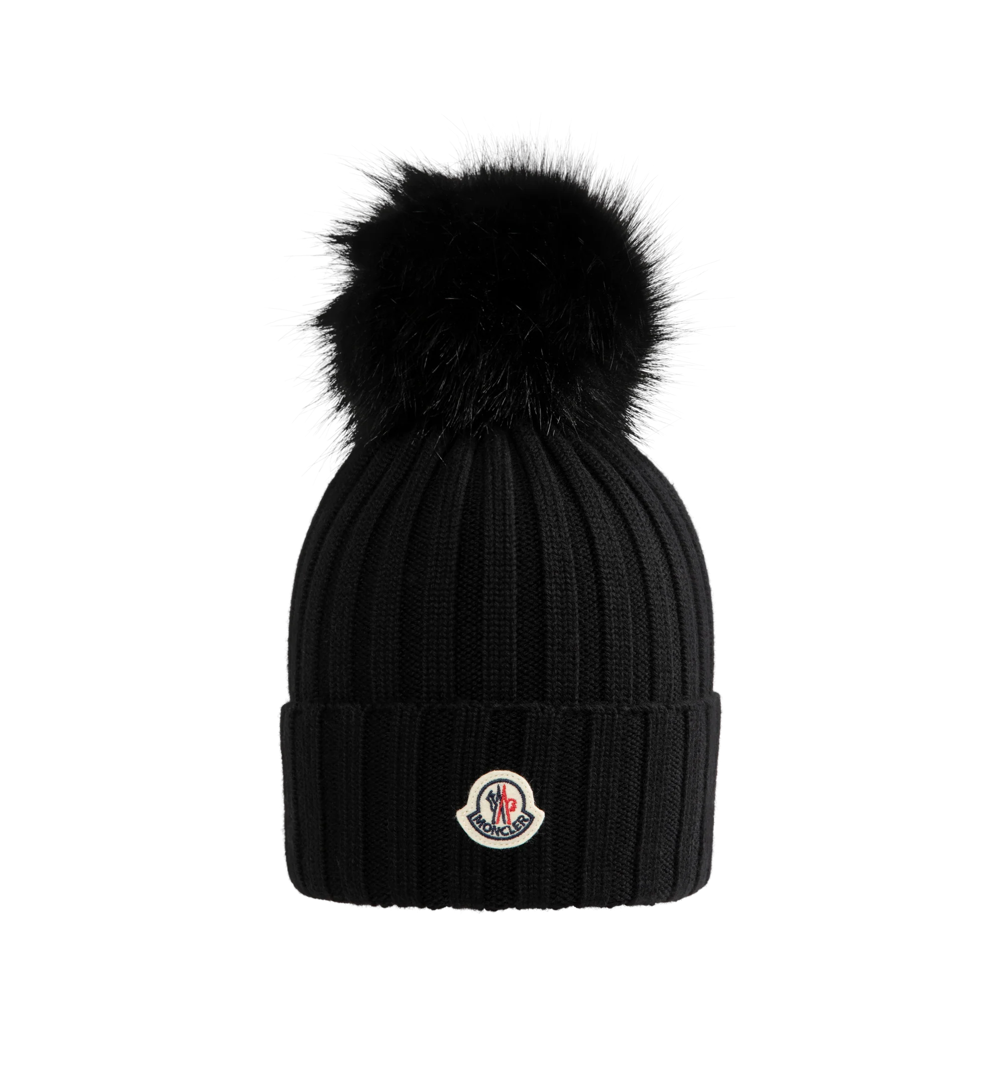 Image 1 of 2 - BLACK - Moncler Wool Beanie with Pom Pom features an English rib-knitting and logo at front and embellished with a faux fur pom pom. Designed to provide warmth, this heavy knit beanie for women adds the finishing touch to cold-weather looks. 100% virgin wool .