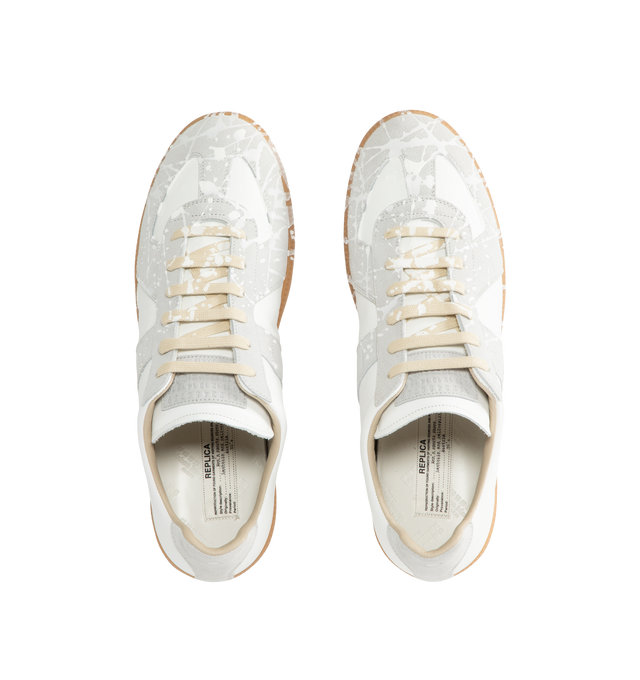 Image 5 of 5 - WHITE - MAISON MARGIELA High Quality Luxury Sneakers featuring a classic low-top silhouette, contrast of matte leather and a patent sprayed finish, paint splatter detail, lace-up construction and rubber sole. Made in Italy. 
