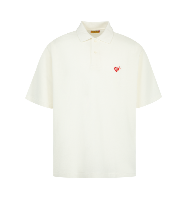 Image 1 of 2 - WHITE - HUMAN MADE Polo Shirt featuring a wide fit, single heart patch on the left chest, short sleeves, polo collar and shell-like buttons with the brand logo. 100% cotton. Made in Japan.
