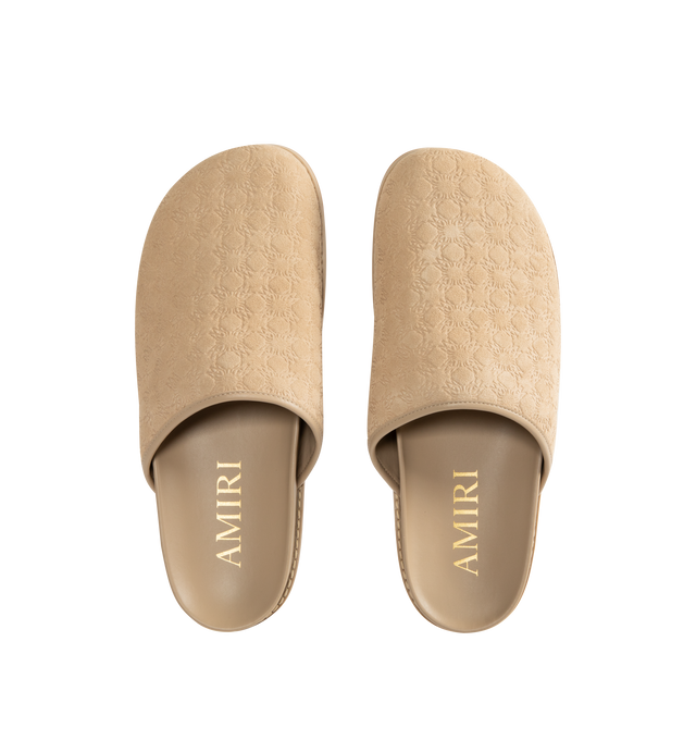 Image 4 of 4 - NEUTRAL - Amiri Mens Clog Slides are crafted from embossed suede leather material. Feature a closed upper, tone-on-tone engraved monogram motif, tapered wraparound construction, and flat rubber outsole with a lightly lugged tread. Upper: Suede Leather; Outsole: Rubber. Made in Vietnam.