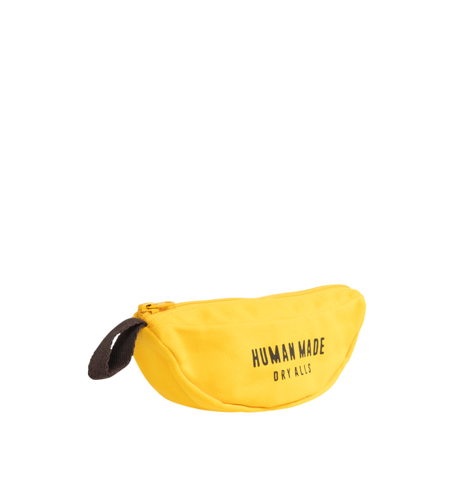 Image 2 of 3 - YELLOW - HUMAN MADE Banana Pouch featuring banana-shaped pouch with a loop attached, made from thick cotton canvas that holds its shape and dye-printed brand logo, fruit sticker style heart logo. 100% cotton.