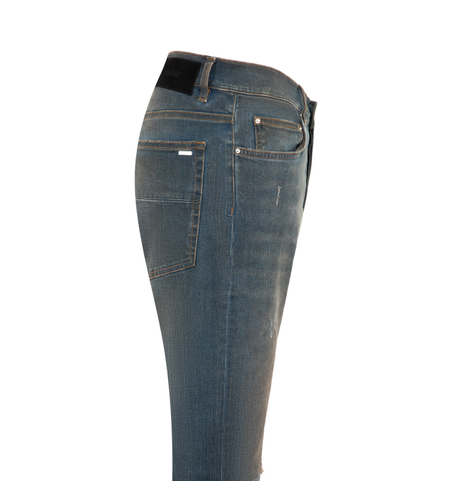 Image 3 of 3 - BLUE - Amiri Mens Ultrasuede MX1 Jeans are crafted from Italian stretch denim. Feature a slim fit, five-pocket styling, hand-distressed finish, pleated ultrasuede repair panels, button and zip closure, and signature MX1 construction. Main Material: 92% Cotton, 6% Elastomultiester, 2% Elastane. Made in USA. 