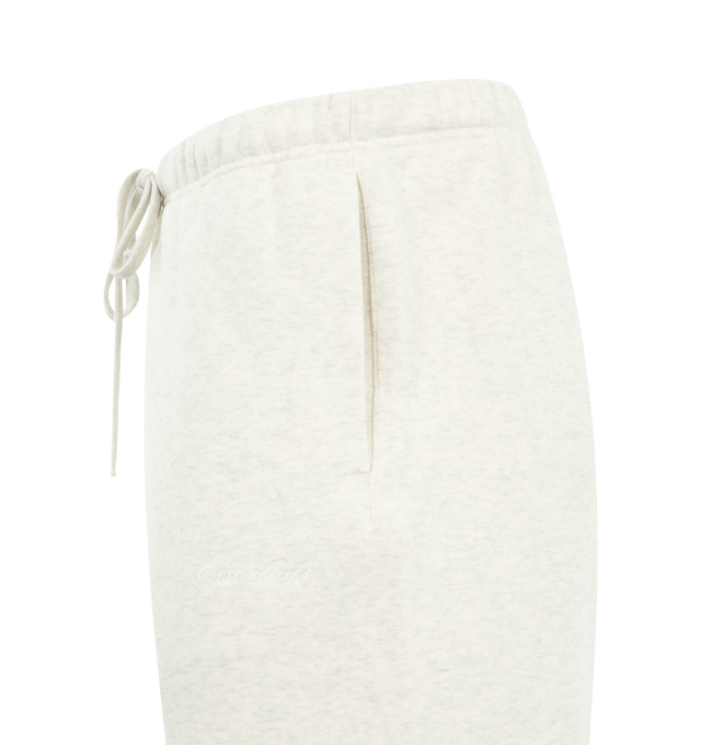 Image 3 of 3 - WHITE - FEAR OF GOD ESSENTIALS Signature Classic Sweatpant featuring 380GSM core fleece, relaxed silhouette, elastic hem, encased elastic waistband with elongated drawcords, side seam pockets, embroidered Essentials signature logo on the leg and an Essentials signature label at the center front. 80% cotton, 20% polyester.