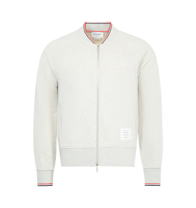 Image 1 of 3 - GREY - THOM BROWNE Pique Loopback Bomber Sweatshirt featuring french terry sweatshirt, rib-knit stand collar, hem, and cuffs, stripes at collar and cuffs, two-way zip closure, welt pockets and logo patch at front and tricolor grosgrain flag at back collar. 100% cotton. Made in Japan.