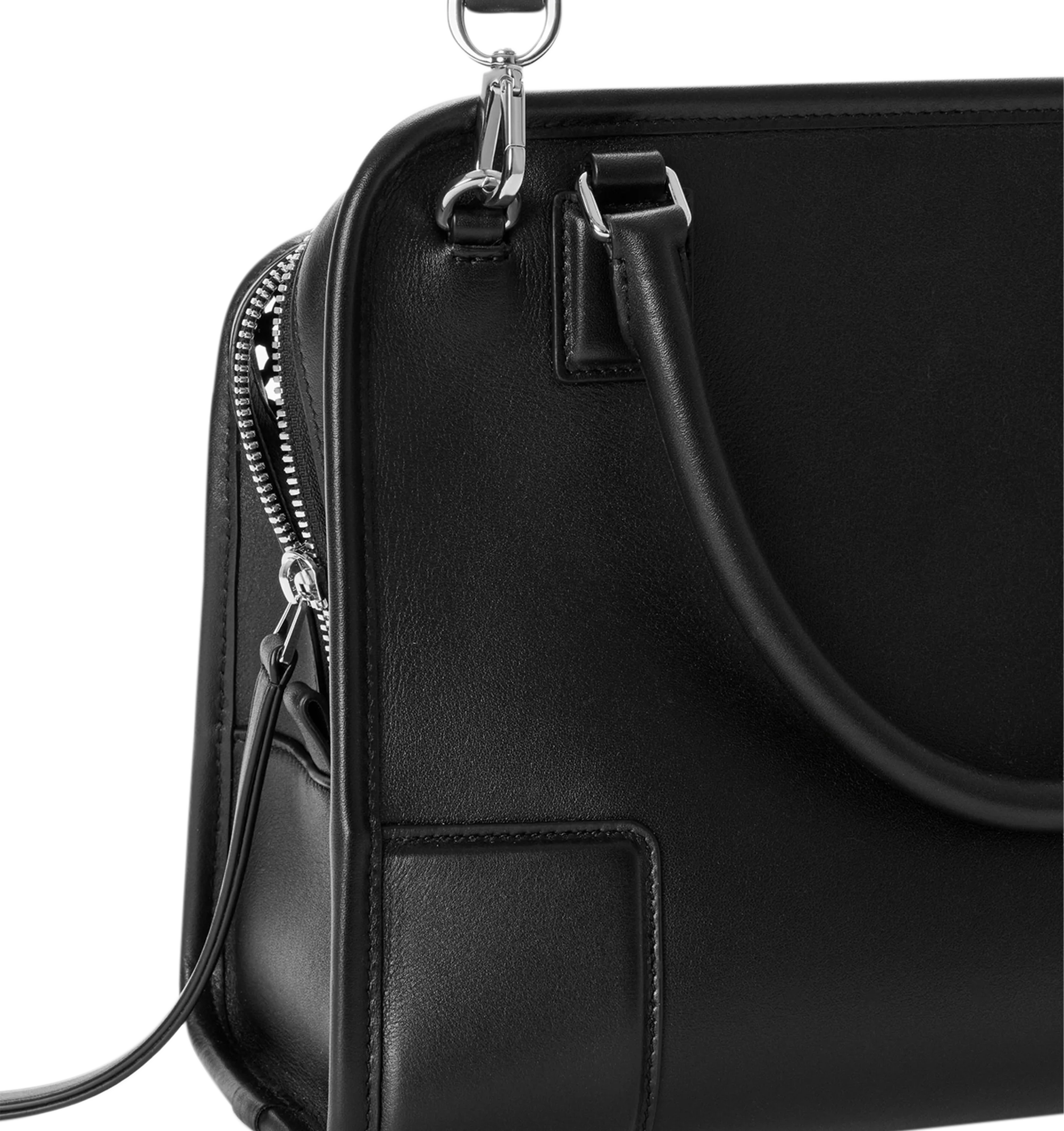 Image 13 of 14 - BLACK - Loewe Women's Medium Amazona 180 Bag is crafted from woven nappa calfskin and features a relaxed silhouette inspired by one of the house's iconic designs. Designed with a single Toron top handle and removable shoulder strap, it can be carried by hand, over the shoulder, or crossbody. A concealed magnetic closure, zip fastening with dual leather pullers, two compartments, an internal flat pocket, and a side D-ring provide functional organization. Finished with palladium-tone hardware 