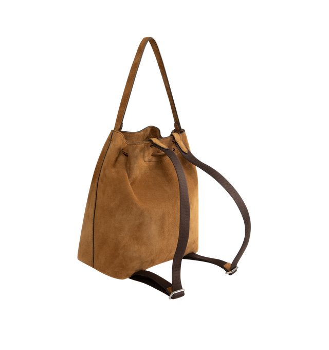 Image 2 of 3 - BROWN - THE ROW Backpack 9 in suede featuring a toggle fastening top, smooth leather trim, gold hardware, 2 adjustable, rivet fastening straps, 1 top handle, logo embossed purse feet at underside, single interior compartment with 1 slit pocket, key ring inside and suede lining. 10.5 W x 10.5 H. 100% calfskin leather. Made in Italy.