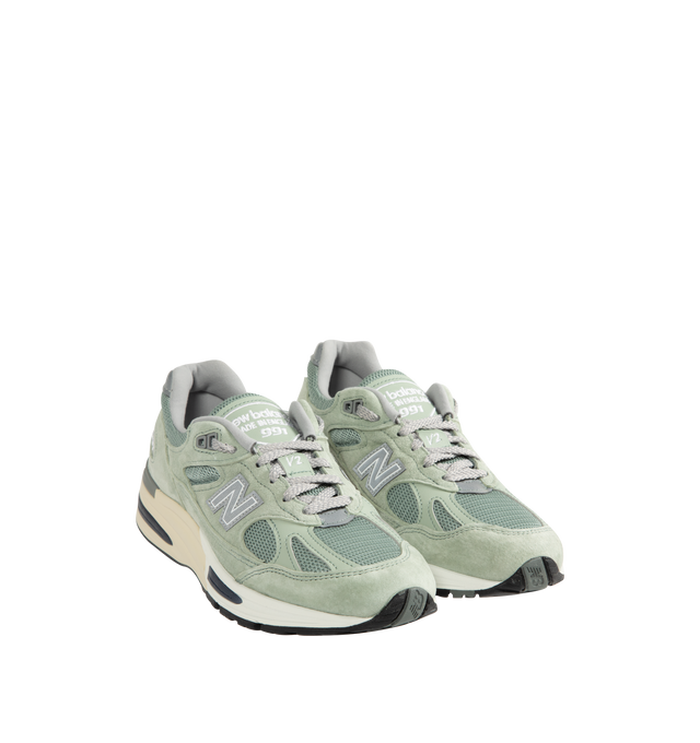 Image 2 of 5 - GREEN - New Balance Mens Made in UK 991v2 Sneakers feature a mesh upper with premium pigsuede and synthetic overlays. Designed with FuelCell foam cushioning, ENCAP midsole technology, semi-translucent ABZORB SBS pods, reflective detailing, debossed "N" logo, embroidered "v2" tongue branding, and a durable rubber outsole. Upper: Mesh, Pigsuede, and Synthetic; Midsole: FuelCell, ENCAP, and ABZORB SBS. Made in the UK.