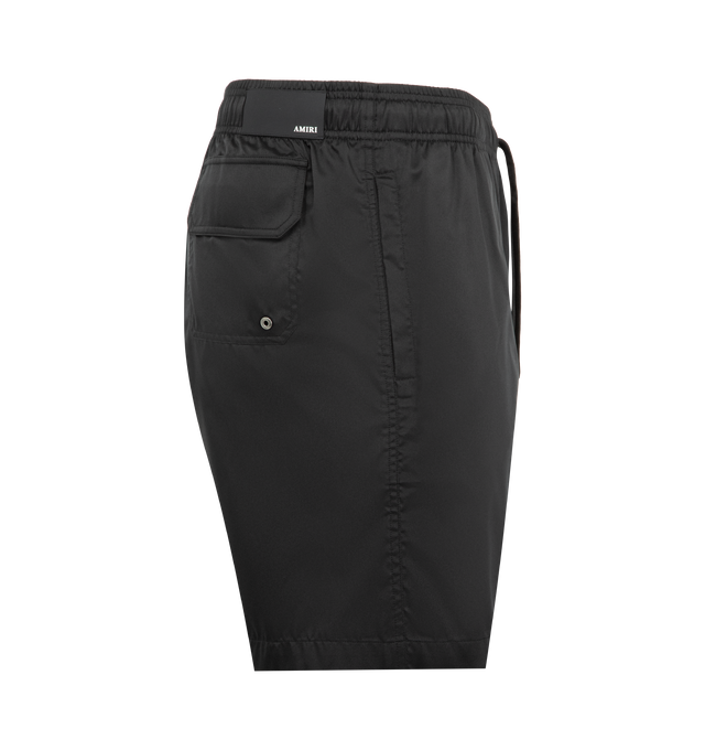 Image 3 of 3 - BLACK - AMIRI Chateau Crest Swim Trunks featuring a Chateau Crest logo on the left leg, back flap pocket, elasticized drawstring waist, side-seam and back flap pockets and pulls on. 100% polyester. Made in Portugal.